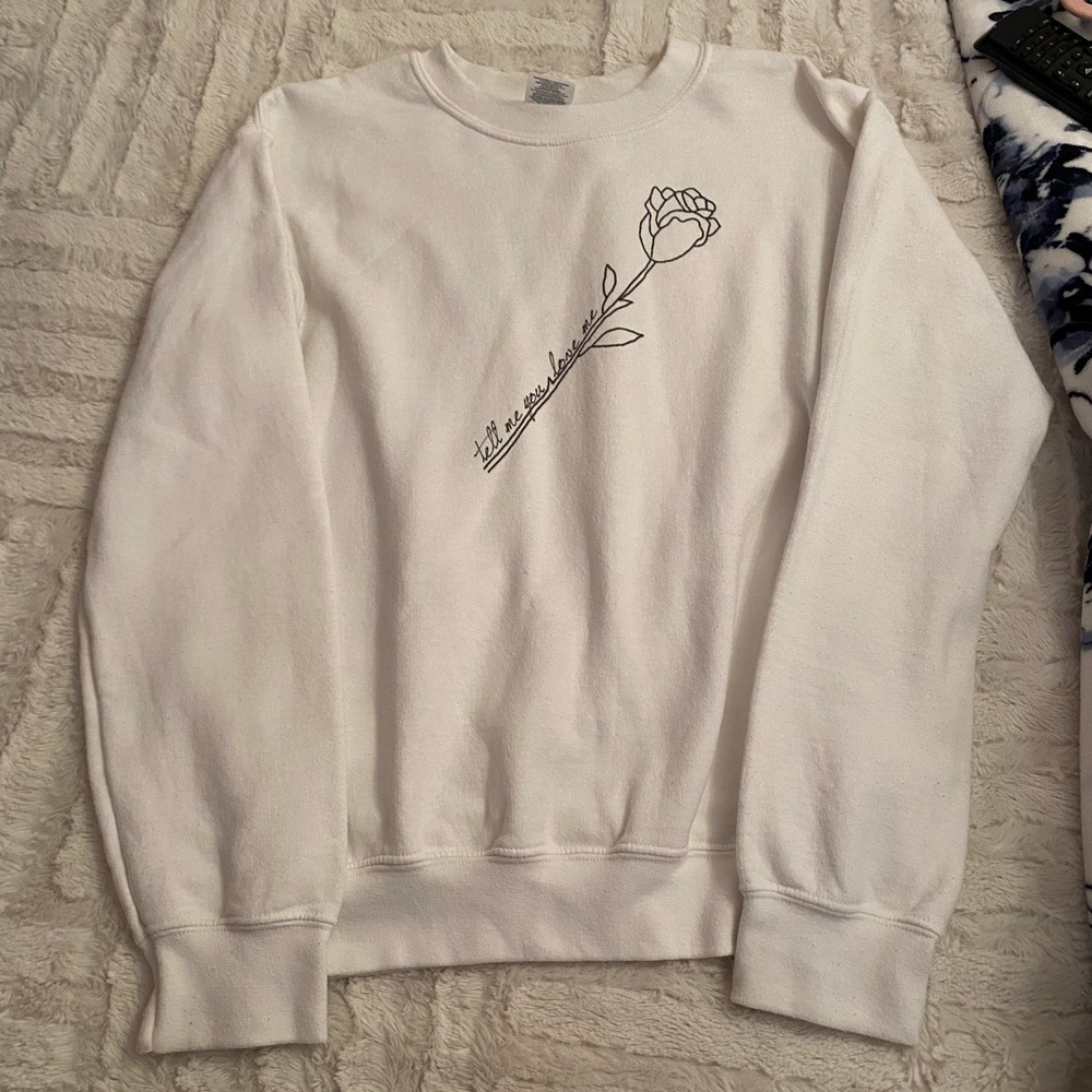White crewneck. Size S. Wording: ‘Tell Me You Love Me’.